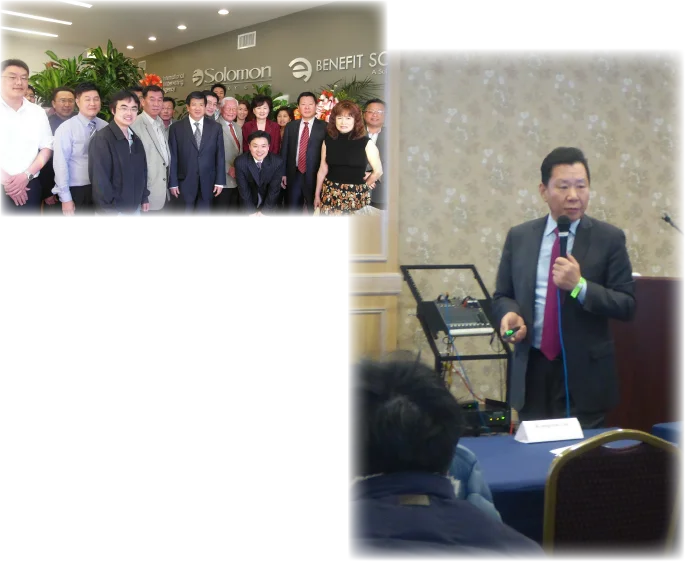 A group photo of the chairman and employees in front of the company logos.